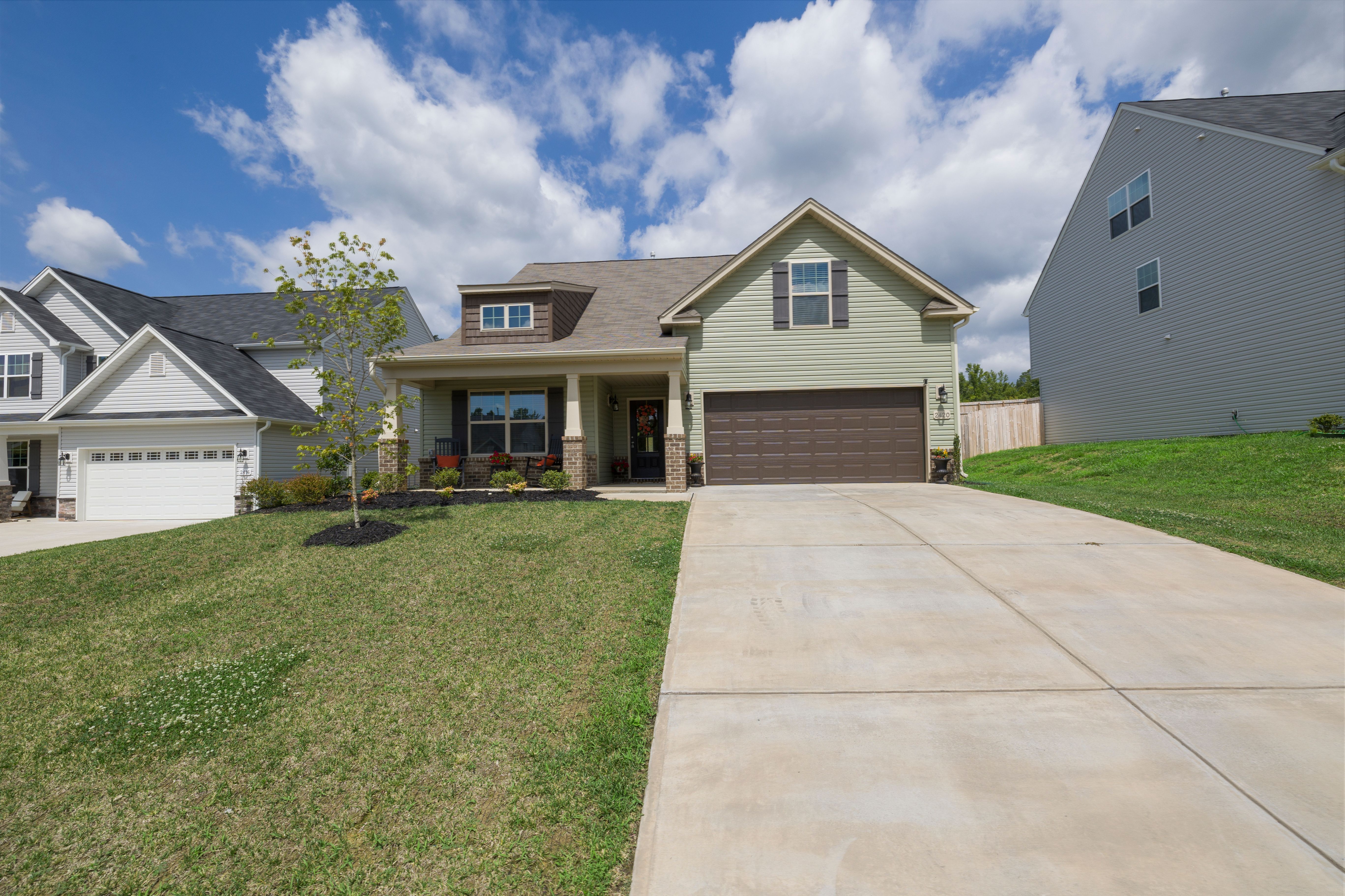 Modern suburban detached house with a driveway under a clear sky